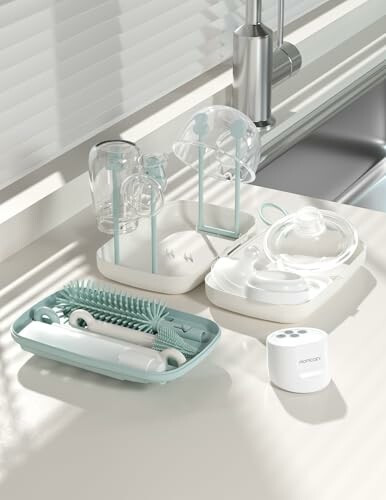 Baby bottle cleaning set on a kitchen counter.