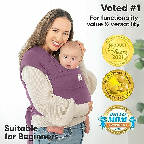 Woman holding baby in a purple carrier with award badges