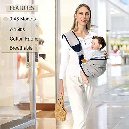 Mother carrying baby in a sling at shopping mall