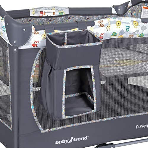 Baby playpen with attached storage pocket and playful animal design