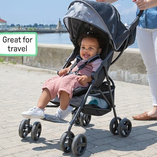 Smiling baby in stroller by waterfront, labeled great for travel.