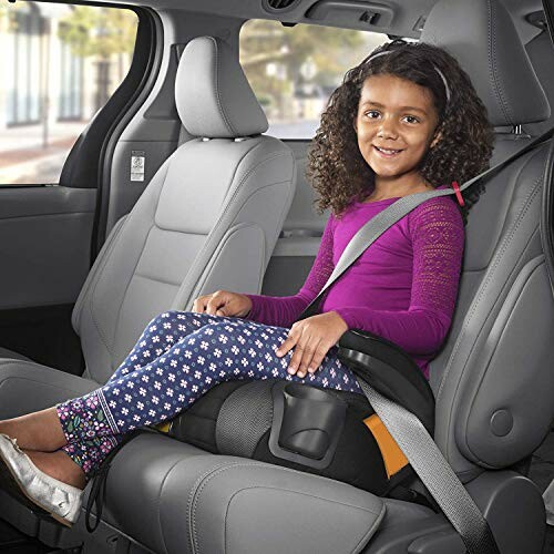 Child sitting in a booster car seat in a vehicle