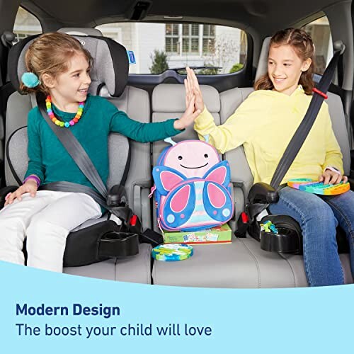 Two children in car seats high-fiving, with a colorful backpack between them.