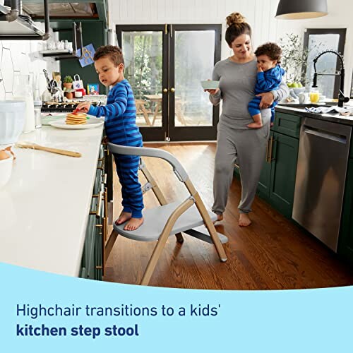 Mother with two children in kitchen using step stool