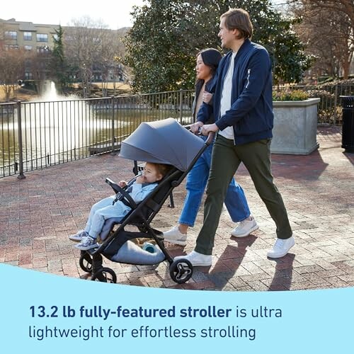 Family walking with a lightweight stroller by a pond