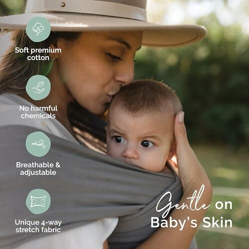 Mother kissing baby on the head, promoting gentle cotton fabric benefits.